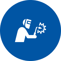 Worker welding sparks wearing helmet on blue